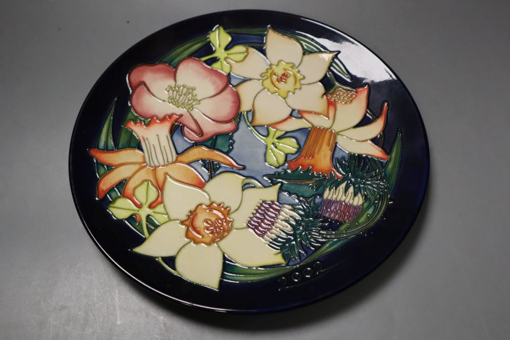A Moorcroft Elizabeth II Golden jubilee 2002 plate, tube lined with flowers of the British Isles, designed by Emma Bossons,